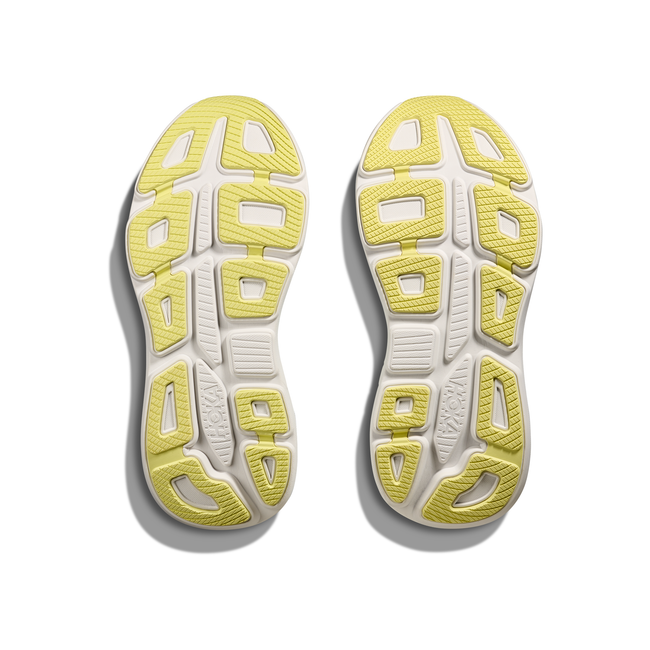 Soles of Women's Hoka Bondi 9 Running Shoes in mint green upper with a white sole and yellow tread