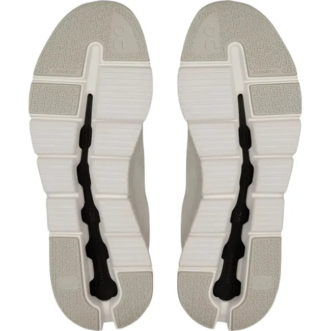 Soles of Women's On Cloud Cloudrift Shoes in beige and white tread with a center black Speedboard