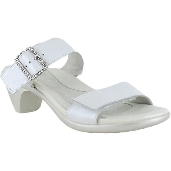 Lateral side angled view of the Naot Women's Recent slide heel sandal in white pearl leather, showing no backstrap for easy slip on, jeweled buckle on padded instep strap, and hook-and-loop velcro feature on both straps. Stands on on a 2-inch heel illusion TPR sole.