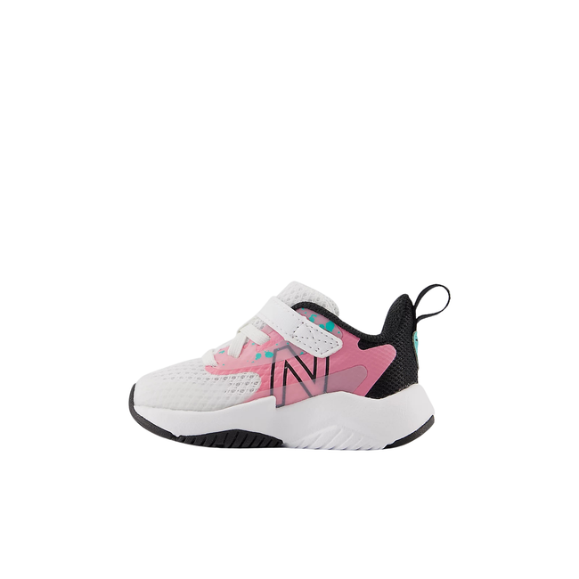 Medial side of velcro New Balance Kids' Rave Run V2 Running Shoe in White, Real Pink, & Black