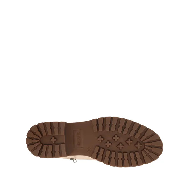 Sole of Women's Taos Downtown Boot in ivory leather with cork midsole and brown rubber tread