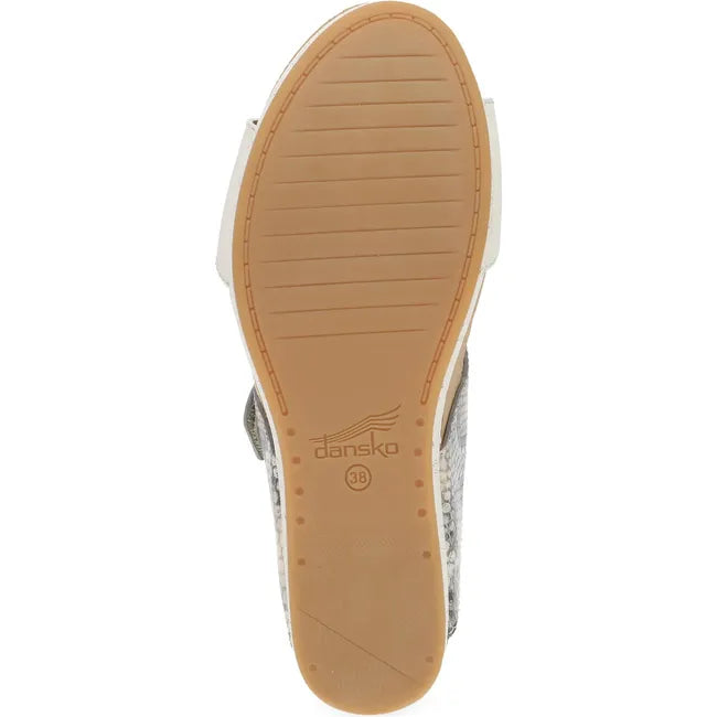 Sole of Women's Dansko Shannon Wedge Sandal in gray snakeskin with tan outsole