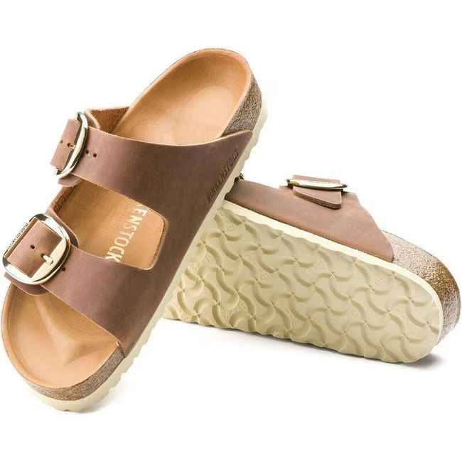 Upper and sole of Birkenstock Women's Arizona Big Buckle Oiled Leather Sandals in cognac