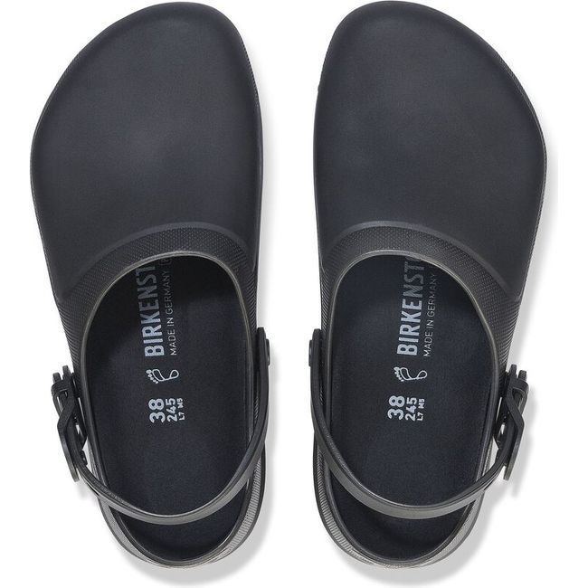 Top view of a pair of jet black Birkenstock Unisex Birki Air 2.0 Professional Clogs showcasing the contoured PU insoles. The clogs feature a fluid-resistant design ideal for healthcare and utility professions, with  removable insoles lined with microfiber for moisture-wicking properties. Around the heel, there are adjustable detergent-friendly backstraps.