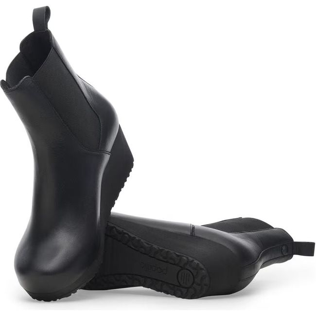 Upper and sole of Women's Birkenstock Ebba Slip On Narrow Wedge Boots in black leather