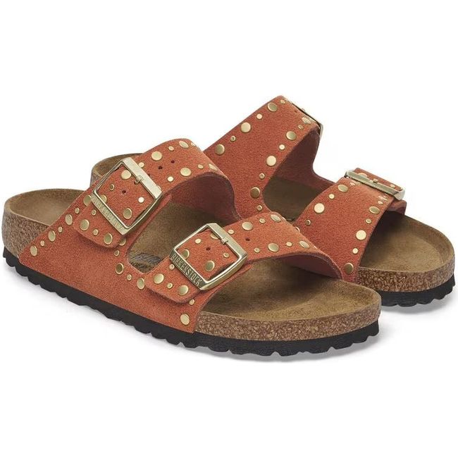 Pair of a Birkenstock Women's Arizona Rivet Narrow Sandals in dark rust orange