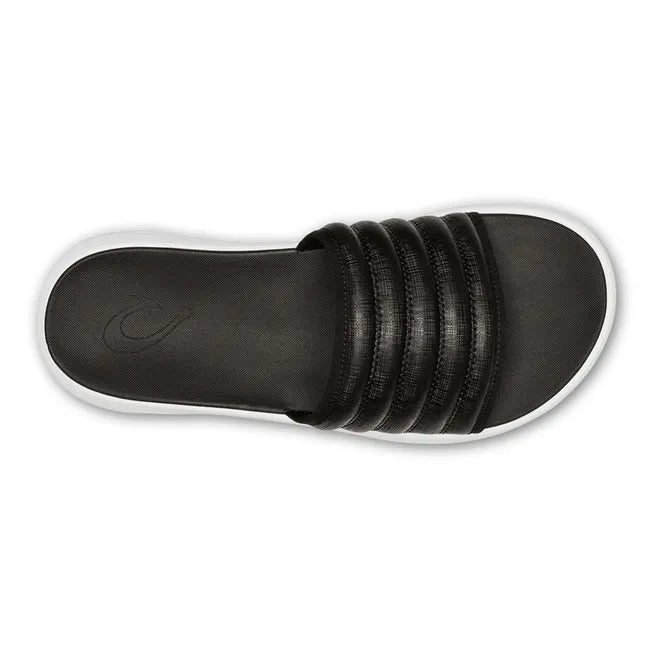 Top down view of Water-Resistant Black OluKai Komo Slide with white sole