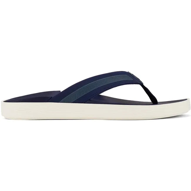 Lateral view of Men's Olukai Leeward Flip Flop Beach Sandal in navy with a white sole