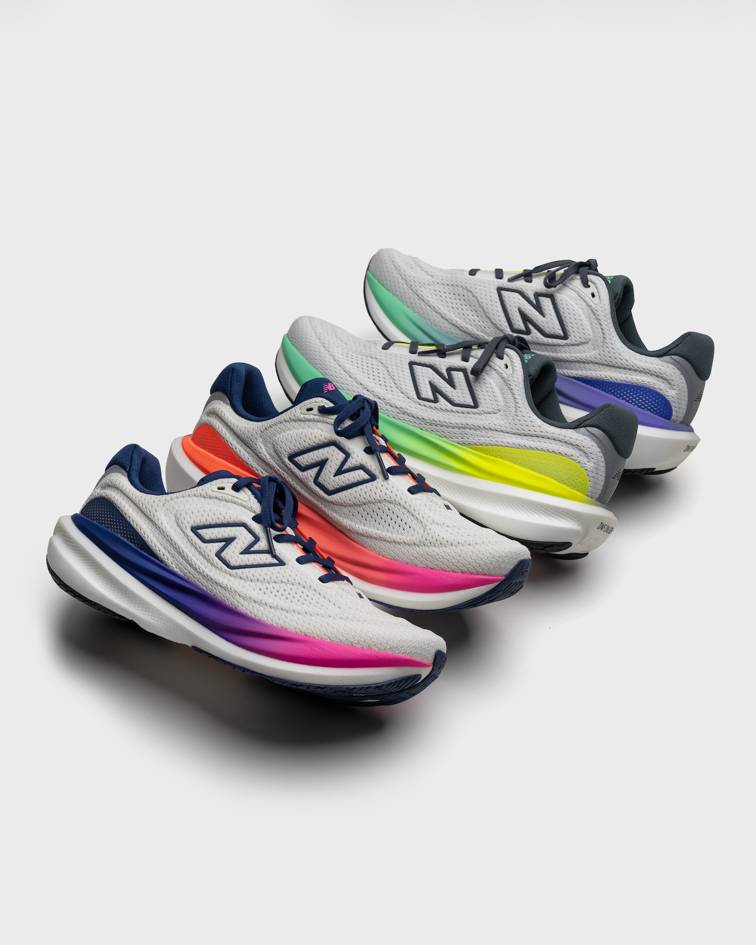 New Balance 1080v15 running shoes in four gradient colorways arranged in a diagonal banner layout on a white background