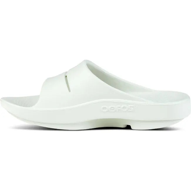 Medial side of Unisex OOFOS OOahh Slide Sandal in mint green