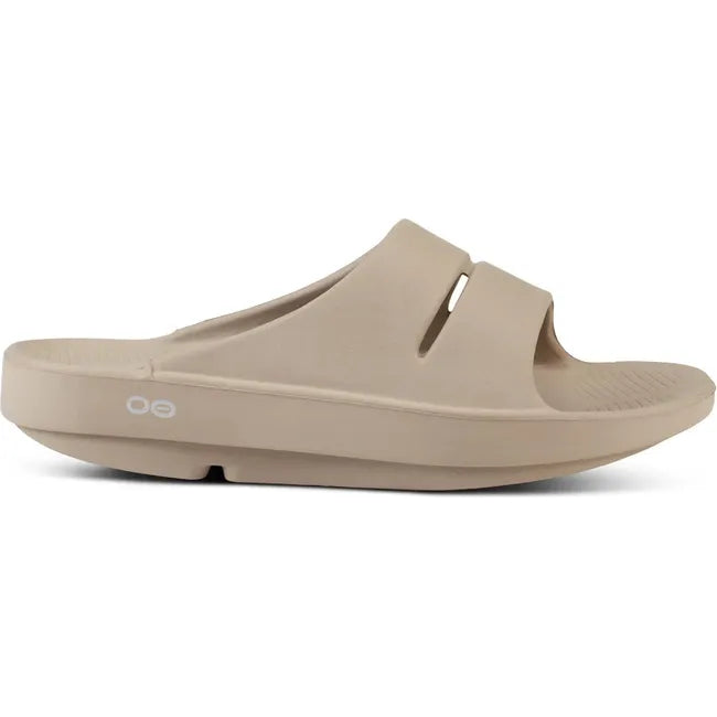 Lateral side of Unisex OOfos OOahh Slide Sandal in Nomad Beige