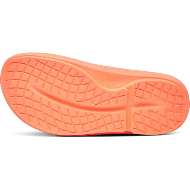 Sole of Unisex OOfos OOahh Slide Sandal in Sunburst Orange