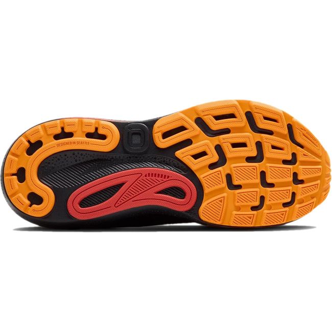 Sole of men&#39;s Brooks Adrenaline GTS 24 running shoe in black with orange and red tread