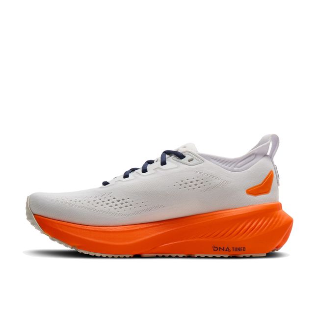 Medial side profile of Brooks Glycerin 23 in white and orange showing plush cushioned midsole and smooth transition geometry