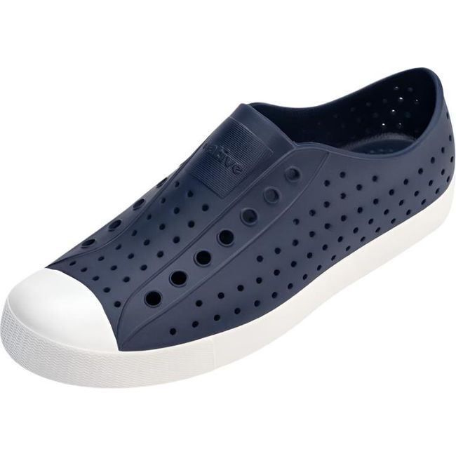 Overhead view of the Native Big Kids' Jefferson Shoe in navy blue, featuring a slip-on design, lightweight and hand-washable Sugarlite™ material, a perforated upper similar to Crocs, a white toe cap, and a white sole.