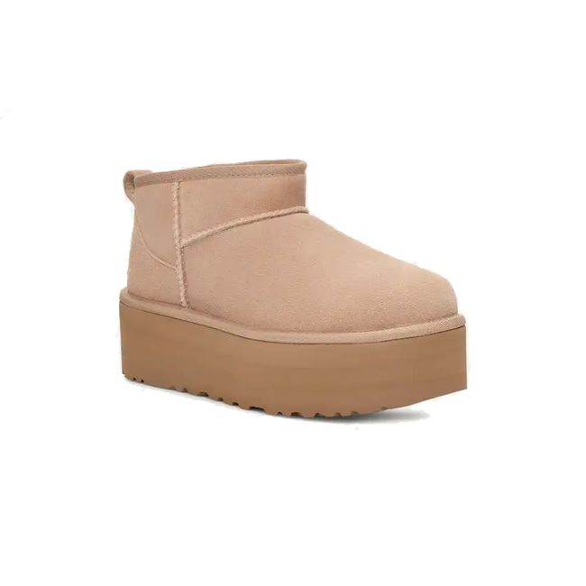 Angled side of UGG Women&#39;s Classic Ultra Mini in Sand Beige Suede