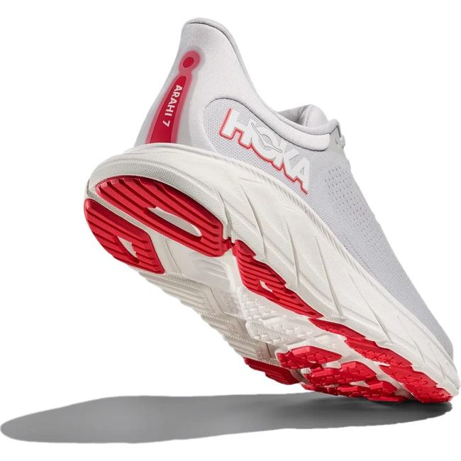 Heel angled up showing tread of Hoka Women&#39;s Arahi 7 Running Shoe in Cosmic Grey and Ruby Red