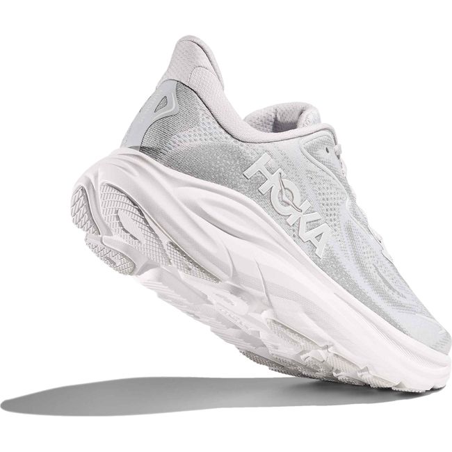 Heel angled up showing tread of Women's Hoka Clifton 10 Running Shoe in Cosmic Grey Stardust