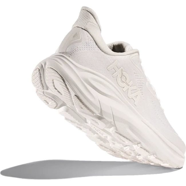Heel angled up showing tread of Women's Hoka Clifton 10 Running Shoe in all White 
