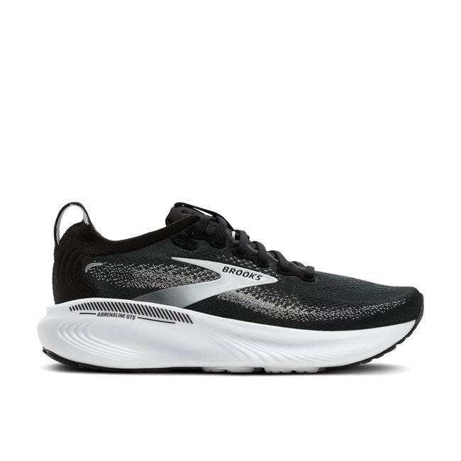 Lateral profile of Brooks Adrenaline GTS 25 women's shoe in black showing white plush midsole and Brooks branding