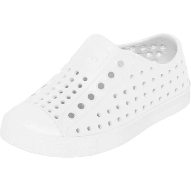 Overhead view of the Native Kids' Jefferson Shoe in shell white featuring a slip-on design, lightweight and hand-washable Sugarlite™ material, a perforated upper similar to Crocs, a white toe cap, and a white sole.