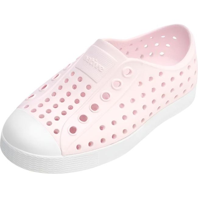 Overhead view of the Native Kids' Jefferson Shoe in pink, featuring a slip-on design, lightweight and hand-washable Sugarlite™ material, a perforated upper similar to Crocs, a white toe cap, and a white sole.