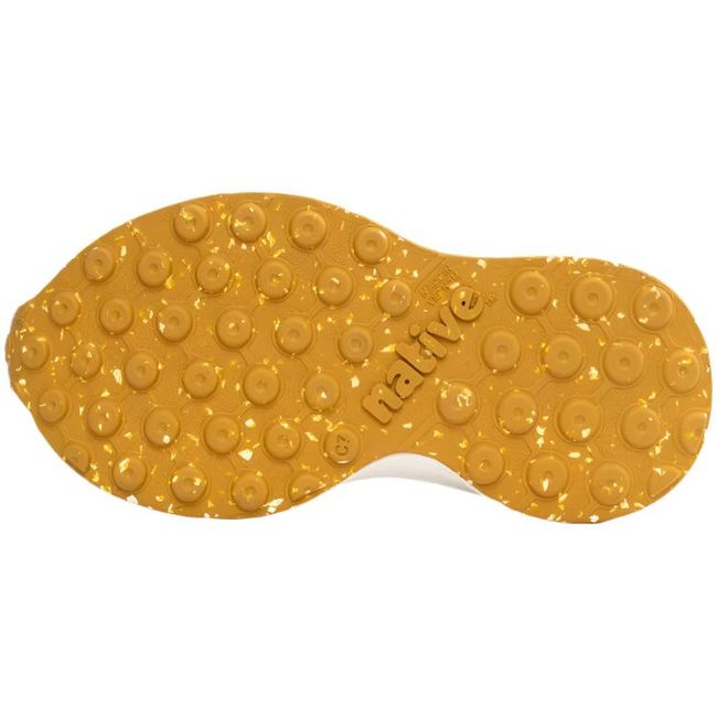 Sole view of the Native Big Kids' Robbie Shoe in pigeon gray, showcasing the ultra-grippy tan rubber outsole with flecks of white.