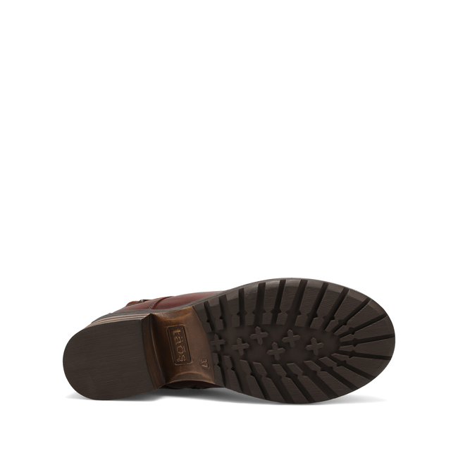 Outsole of the Taos Mini Crave ankle boot in cognac brown leather showing the tread