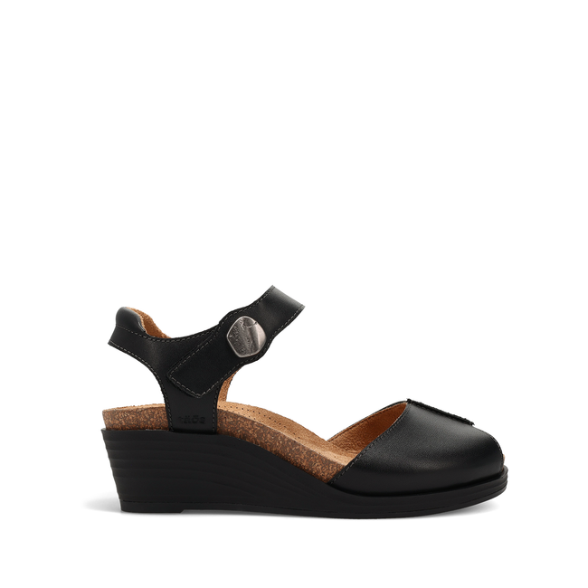 Lateral profile of the Women's Taos Promise Wedge sandal in black