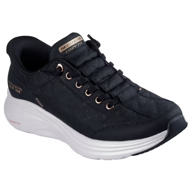 Angled Black Skechers Slip-ins Cozy Fit Golden Hour women’s sneaker with quilted upper and rose‑gold accents