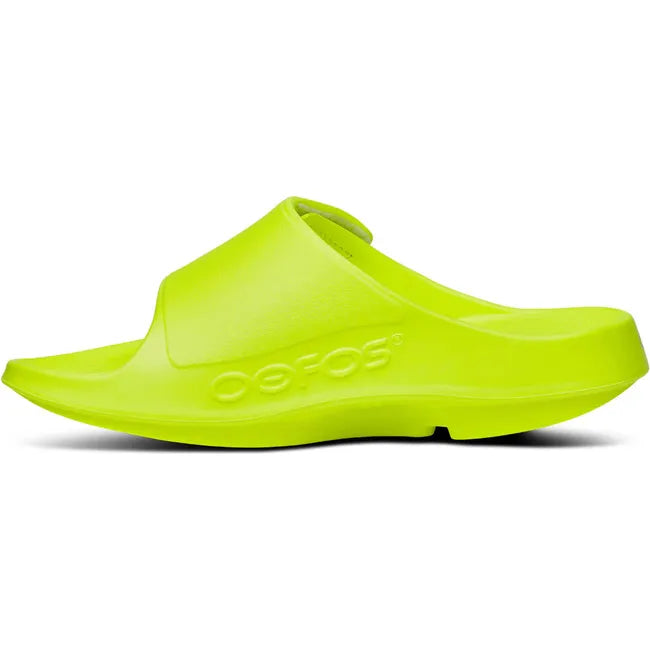 Medial side of Unisex OOfos OOahh Sport Flex Slide Sandal in Electro Yellow with velcro strap