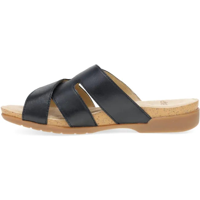 Dansko Regan slide sandal in black leather, side profile showing cork midsole