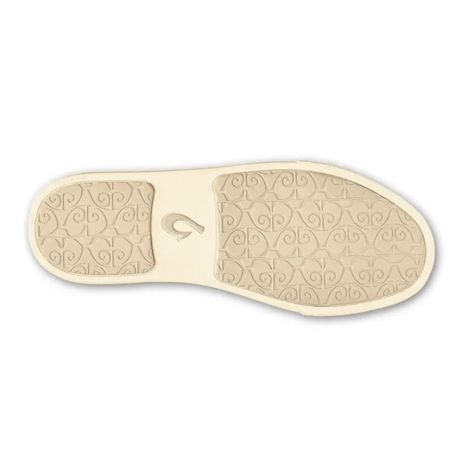 Sole of slip on Women's Olukai Pehuea Shoe in beige mesh upper with off white sole and black tread