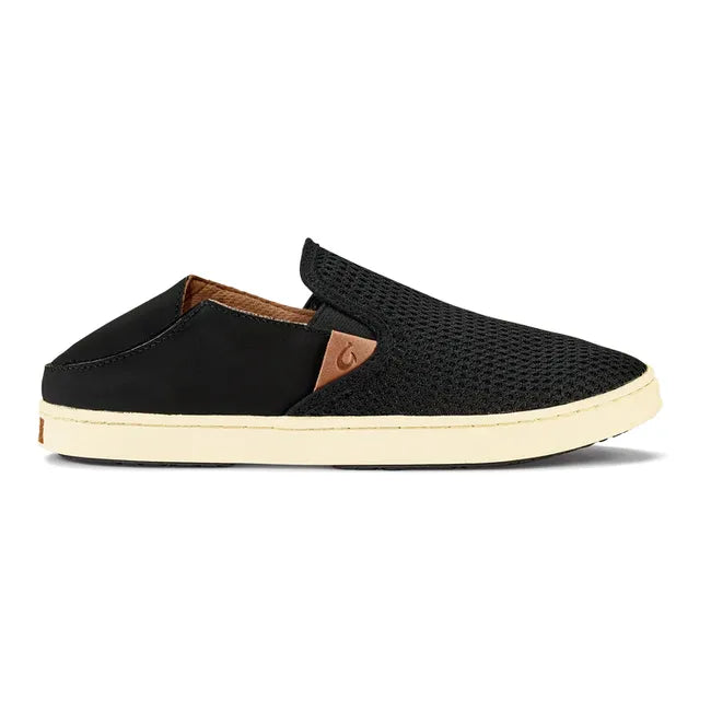Heel down lateral side of slip on Women's Olukai Pehuea Shoe in black mesh with off white sole.