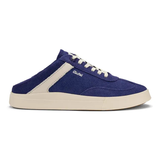 Women's Olukai Haupu Sneaker in navy blue suede with the heel down for easy slip on