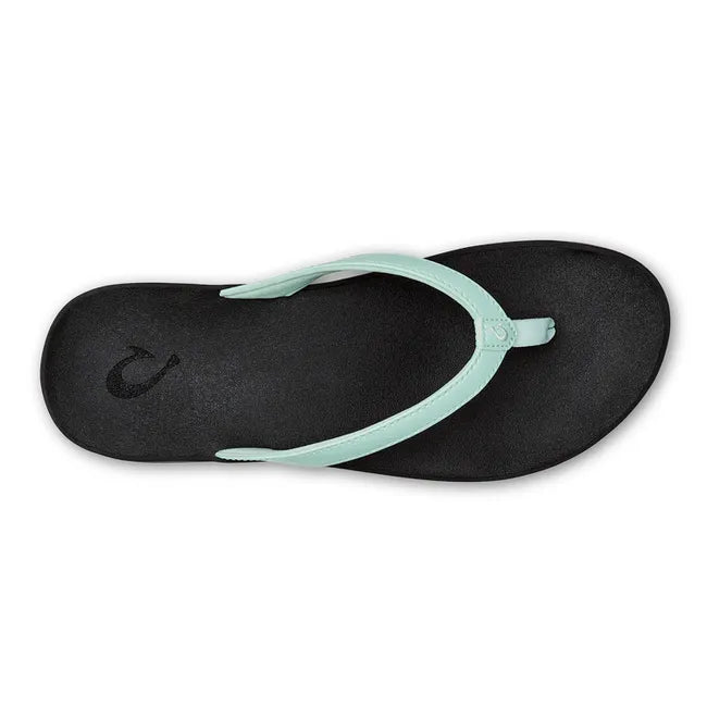 Top down view of Women's Olukai Puawe Flip Flop with a sea glass green colored upper and black sole.