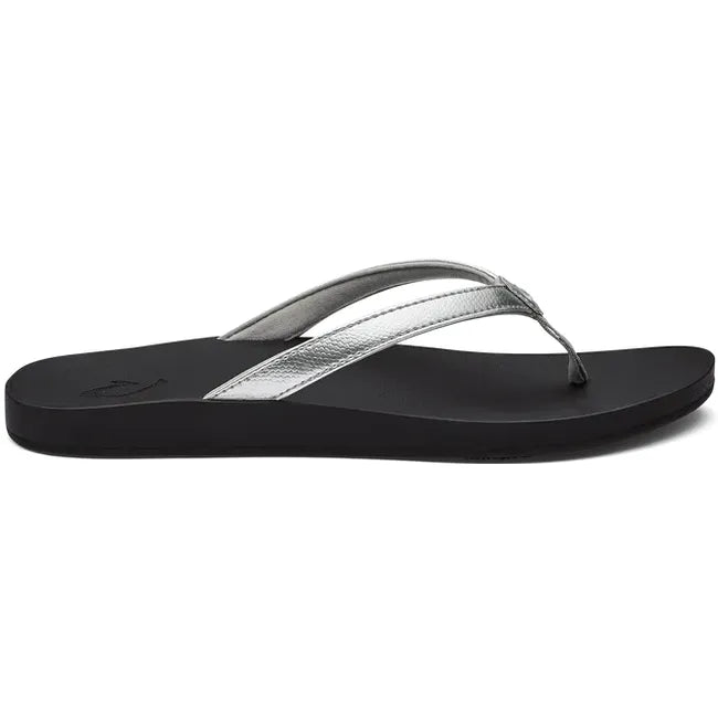 Lateral view of Women's Olukai Puawe Flip Flop with a silver upper and black sole.