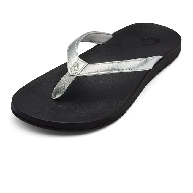 Front angled view of Women's Olukai Puawe Flip Flop with a silver upper and black sole.