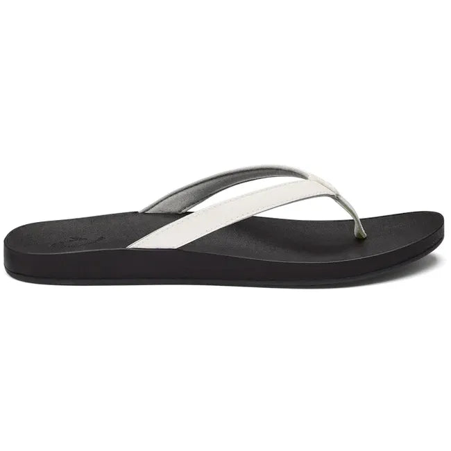 Lateral view of Women's Olukai Puawe Flip Flop with white upper and black sole.