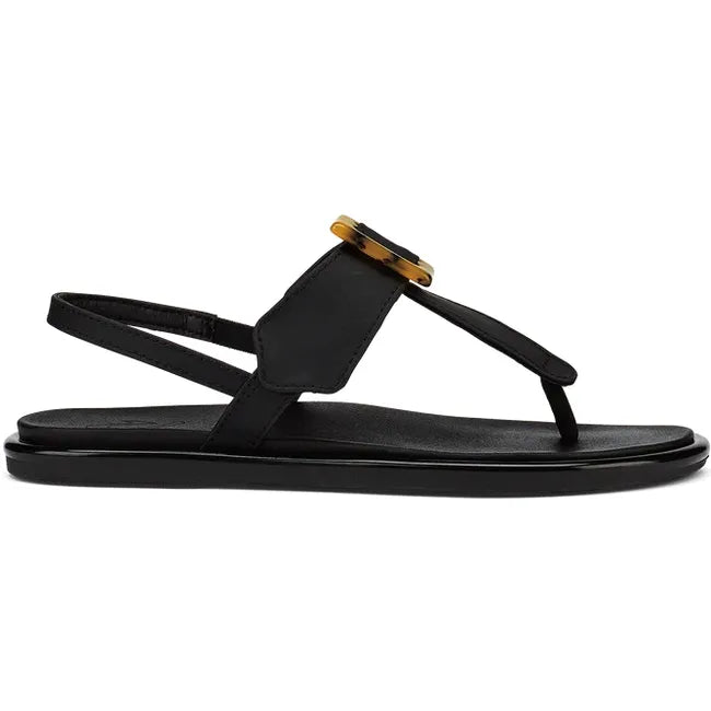 Lateral side of women's Olukai Lai T Bar sandal in black leather with brown buckle on instep