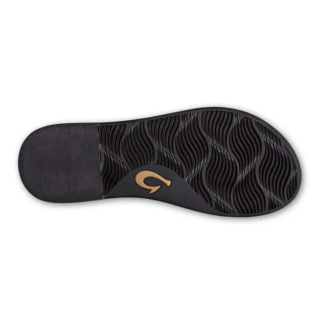 Sole of women's Olukai Lai T Bar sandal with black tread