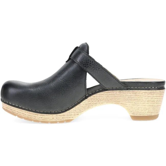Dansko Women's Leandra Clog in black leather, side view showing the stacked heel