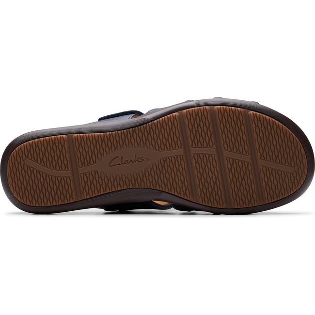 Sole of Women&#39;s Clarks Kitly Slide Sandal in Navy Leather with brown tread