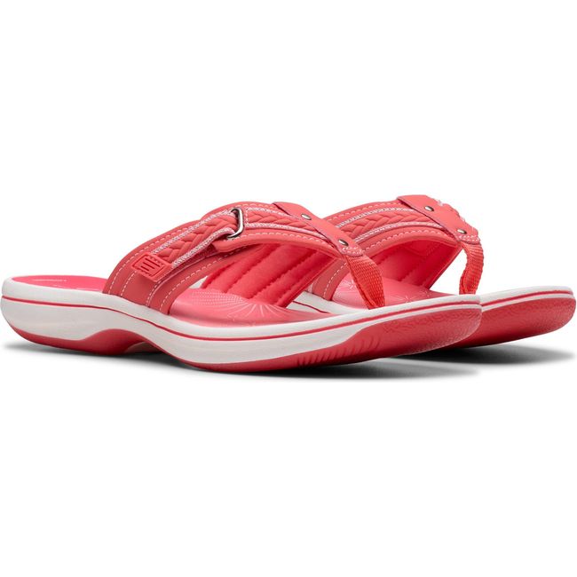 Pair of Women&#39;s Clarks Breezy Sun Flip Flop Sandals in Bright Coral Pink with velcro straps