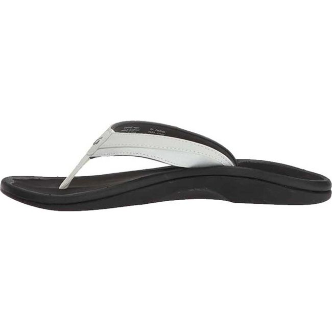Medial side of Women's Olukai ‘Ohana Flip Flop in white leather and black sole