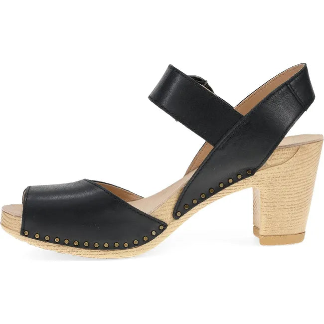 Medial side of Women's Dansko Tamra Heel in Black Pull Up leather with velcro backstrap