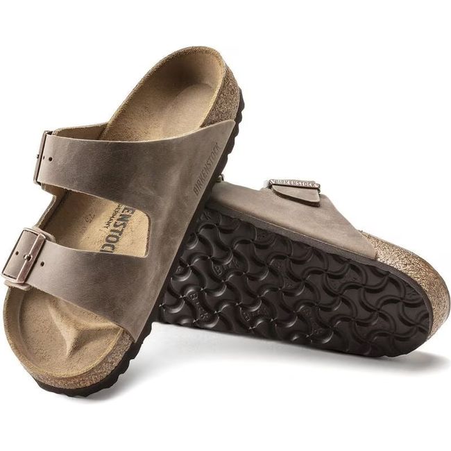 Upper and sole of Birkenstock Unisex Arizona Oiled Leather Sandals in tobacco brown