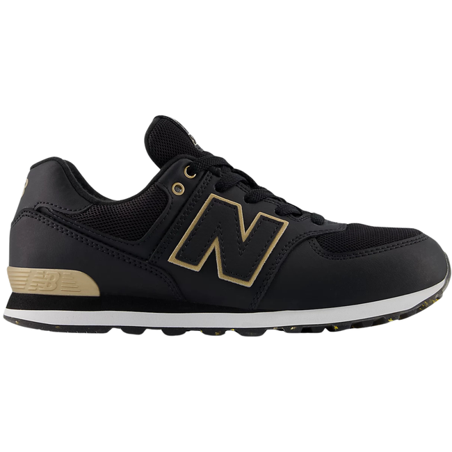 Side of New Balance Kids' 574 Lifestyle Shoe (Toddler/Little Kid) in Black with Gold