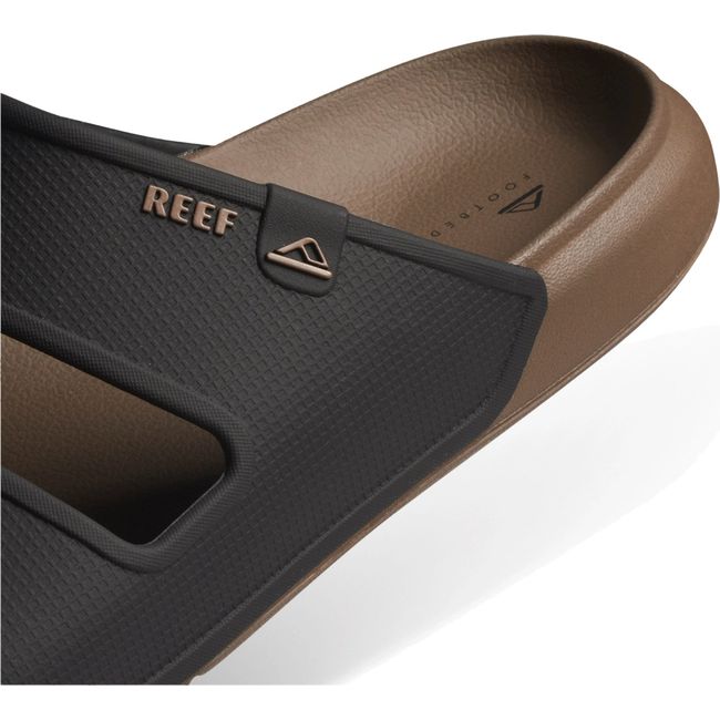 Heel close up of Men's Reef Oasis Double Up Slide Sandal in Fossil brown and Black showing heel cup