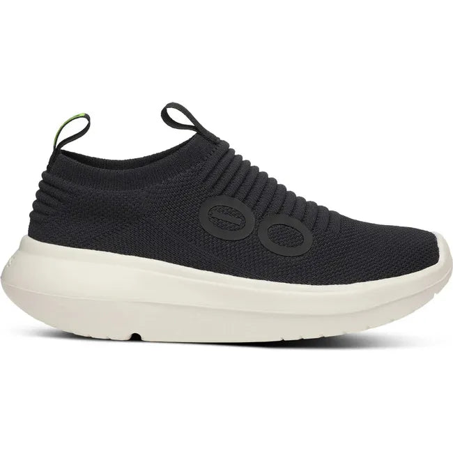 Lateral side of Women&#39;s OOfos OOmy Zen Sneaker in Black and Chalk white
